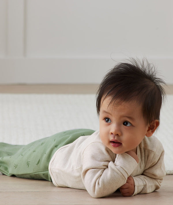 Baby crawling wearing Arm Warmers Oatmeal Marle and Pouch in Willow