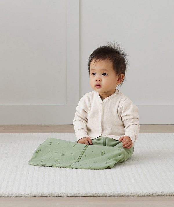 Baby sitting, wearing Baby sitting wearing Arm Warmers Oatmeal Marle and Pouch in Willow