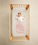 Infant laying in cot wearing Arm Warmers Oatmeal Marle over a Pouch in Daisies