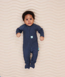 Newborn baby wearing an ergoPouch Long Sleeve Layer 1.0 TOG Ink