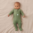 Newborn baby wearing an ergoPouch Long Sleeve Layer 1.0 TOG Moss