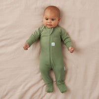 Newborn baby wearing an ergoPouch Long Sleeve Layer 1.0 TOG Moss