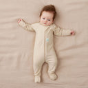 Newborn baby wearing an ergoPouch Long Sleeve Layer 1.0 TOG Vanilla