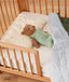Teddy placed on top of a ergoPouch Organic Toddler Pillow Case Daisy Sprinkle