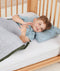 Little boy lying in bed on an ergoPouch low-profile pillow with protector, made from organic, non-irritating materials.