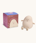 Soft-touch silicone bedtime lamp shaped like a smiling, rounded character with arms and legs, sitting next to its box labeled Blobby Bedtime Lamp by ergoPouch.