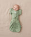 Newborn baby wearing an ergoPouch cocoon swaddle paired with a matching colour butterfly cardi.