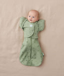 Newborn wearing ergoPouch Butterfly Cardi Willow and a matching Pouch