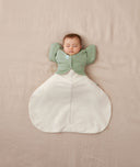 baby asleep in ergoPouch Hip Harness Cocoon Swaddle Bag 0.2 TOG Oatmeal Marle and Butterfly Cardi