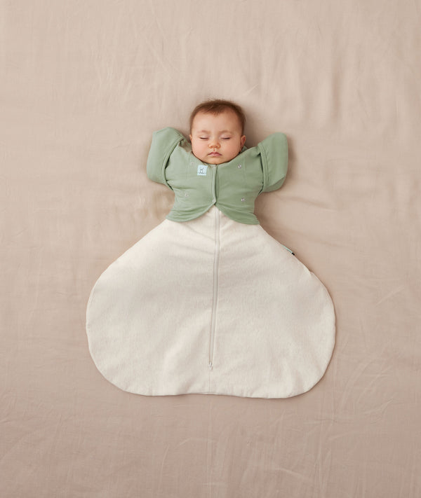 baby asleep in ergoPouch Hip Harness Cocoon Swaddle Bag 0.2 TOG Oatmeal Marle and Butterfly Cardi