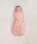 Baby wearing a lightweight ergoPouch Cocoon Swaddle Bag 0.2 TOG Berries with arms in