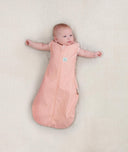 Baby wearing a lightweight ergoPouch Cocoon Swaddle Bag 0.2 TOG Berries with arms out