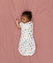 Newborn transitioning to arms-out sleeping, in an ergoPouch Cocoon Swaddle Bag 1.0 TOG Daydream