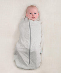 Newborn wearing an ergoPouch Cocoon Swaddle Bag 0.2 TOG Grey Marle with arms in