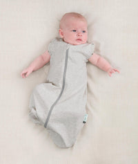 Newborn wearing an ergoPouch Cocoon Swaddle Bag 0.2 TOG Grey Marle with arms out