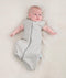 Newborn wearing an ergoPouch Cocoon Swaddle Bag 0.2 TOG Grey Marle with arms out