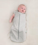 Newborn wearing an ergoPouch Cocoon Swaddle Bag 0.2 TOG Grey Marle with one arm out