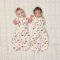 Two babies wrapped in ergoPouch Cocoon Swaddle Bag 1.0 TOG in Bon Appetit