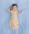 Newborn wearing an ergoPouch Cocoon Swaddle Bag 1.0 TOG Birthday Blobs with arms out