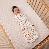 Baby being swaddled in ergoPouch Cocoon Swaddle Bag 1.0 TOG in Bon Appetit