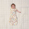 Baby transitioning to arms out sleeping with one arm out of ergoPouch Cocoon Swaddle Bag 1.0 TOG in Bon Appetit