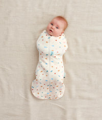 Baby wearing a Cocoon Swaddle Bag 1.0 TOG Desert Bloom