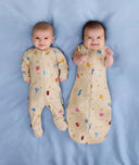 Two babies, one wearing a Cocoon Swaddle Bag 1.0 TOG Birthday Blobs and the other in a Layer