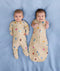 Two babies, one wearing a Cocoon Swaddle Bag 1.0 TOG Birthday Blobs and the other in a Layer