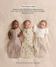 Three babies side by side showcasing three swaddle sleep options: Arms Out, Arms In, and Hands Up with a Butterfly Cardi.