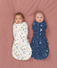 Two babies swaddled in ergoPouch Cocoon Swaddle Bag Daydream and Starbeam, to mimic the wound