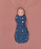Baby cocooned to mimic the wound in an ergoPouch Cocoon Swaddle Bag 1.0 TOG Starbeam