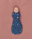 Baby cocooned to mimic the wound in an ergoPouch Cocoon Swaddle Bag 1.0 TOG Starbeam