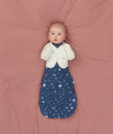 Newborn using Butterfly Cardi Oamteal Marle for arms up sleeping, wearing a ergoPouch Cocoon Swaddle Bag 1.0 TOG Starbeam underneath