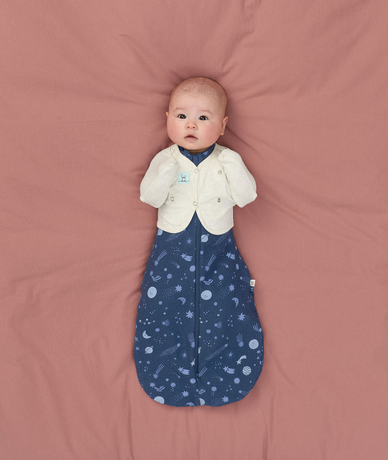 Newborn using Butterfly Cardi Oamteal Marle for arms up sleeping, wearing a ergoPouch Cocoon Swaddle Bag 1.0 TOG Starbeam underneath