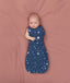 Baby transitioning to arms out sleeping easily with the ergoPouch Cocoon Swaddle Bag 1.0 TOG Starbeam