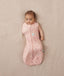 Baby wearing a lightweight ergoPouch Cocoon Swaddle Bag 0.2 TOG Daisies with one arm out