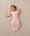 Baby wearing a lightweight ergoPouch Cocoon Swaddle Bag 0.2 TOG Daisies with arms out