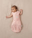 Baby wearing a lightweight ergoPouch Cocoon Swaddle Bag 0.2 TOG Daisies with arms out