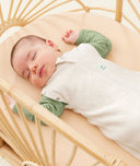 Newborn wearing an ergoPouch Cocoon Swaddle Bag 0.2 TOG Oatmeal Marle with arms out