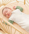 Newborn wearing an ergoPouch Cocoon Swaddle Bag 0.2 TOG Oatmeal Marle with arms out