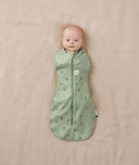 Newborn wearing an ergoPouch Cocoon Swaddle Bag 1.0 TOG Willow