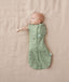 Newborn wearing an ergoPouch Cocoon Swaddle Bag 0.2 TOG Willow with one arm out