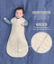 Product infographic showing a baby with both arms out in a Cocoon Swaddle Bag on a blue background, highlighting Organic Cotton and a Two-Way Zip feature with a close-up inset.