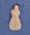 A newborn sleeping peacefully while wrapped snugly in a tan, patterned Cocoon Swaddle Bag 2.5 TOG on a blue fabric background.