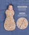Product graphic featuring a sleeping baby in a tan Cocoon Swaddle Bag, highlighting Organic Cotton and a Two-Way Zip feature with a close-up inset.