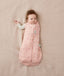 Newborn wearing an ergoPouch Cocoon Swaddle Bag 2.5 TOG Daisies with one arm out