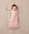 Newborn wearing an ergoPouch Cocoon Swaddle Bag 3.5 TOG Daisies with one arm out