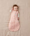 Newborn wearing an ergoPouch Cocoon Swaddle Bag 2.5 TOG Daisies with arms out