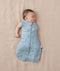 Newborn wearing an ergoPouch Cocoon Swaddle Bag 3.5 TOG Dragonflies with one arm out