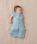Newborn wearing an ergoPouch Cocoon Swaddle Bag 2.5 TOG Dragonflies with one arm out